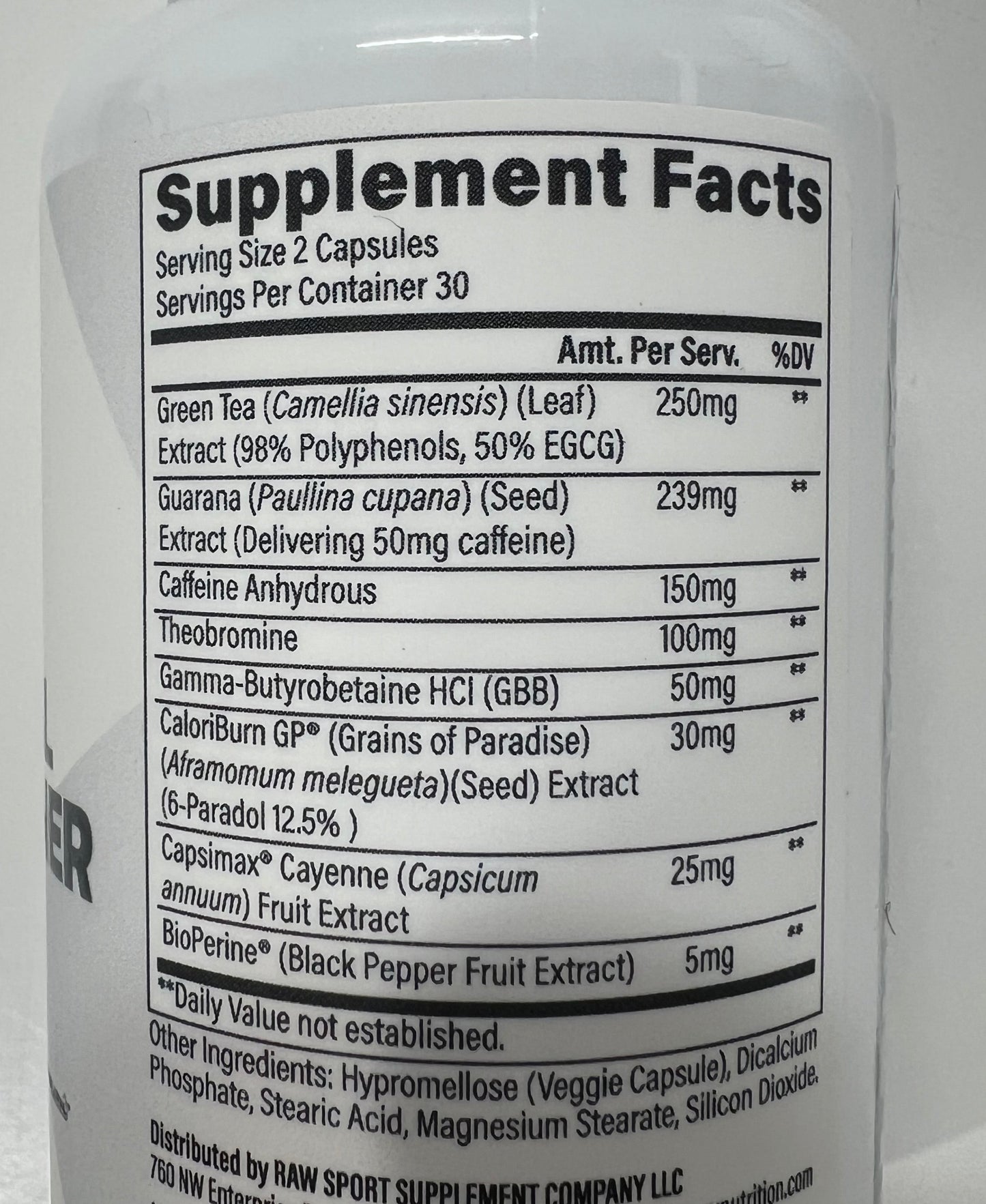 A close-up of a white plastic bottle showing the Supplement Facts label, photographed on a white surface.