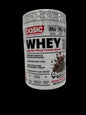 A tub of Basic Supplements Whey Protein Blend in chocolate flavor, shown lying on its side on a white surface.